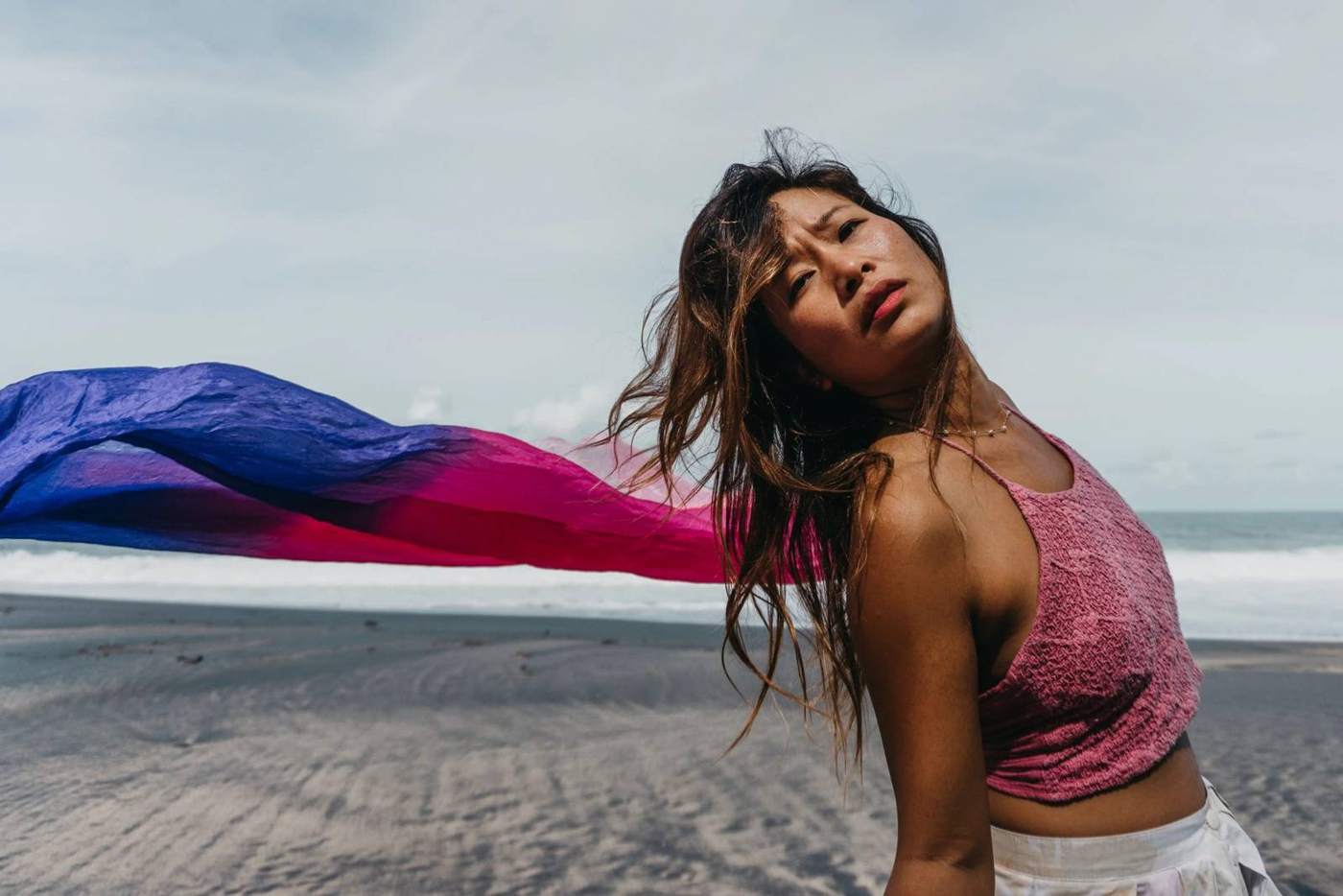 Dancer with flowing fabric on the beach