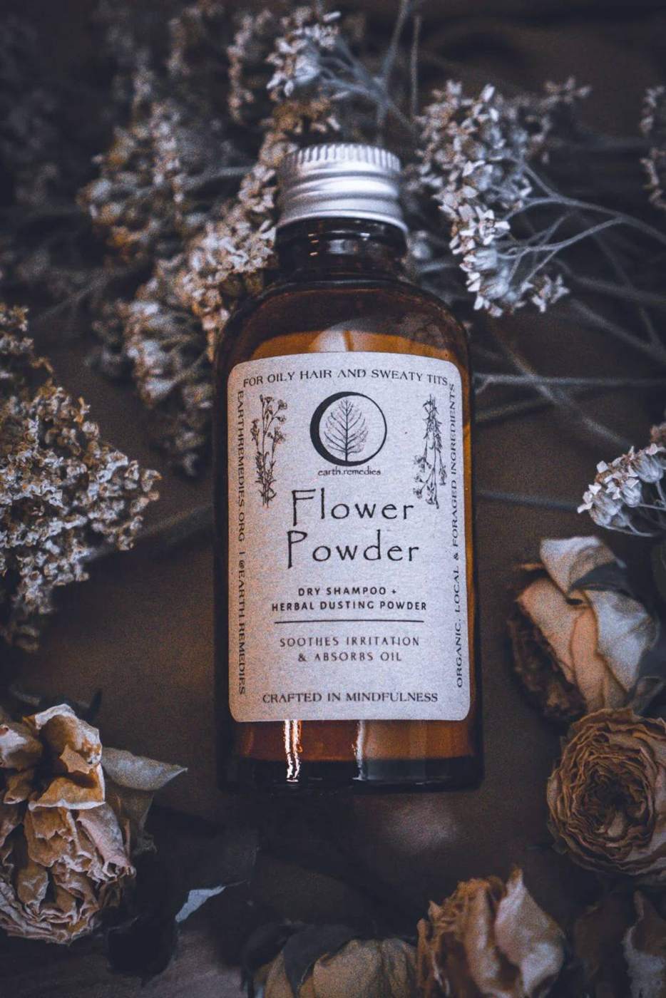 Flower Powder bottle among dried flowers