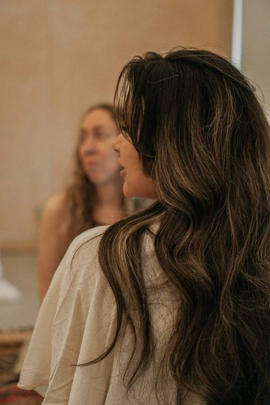 A guest with long hair in warm light at the Wild Honey retreat